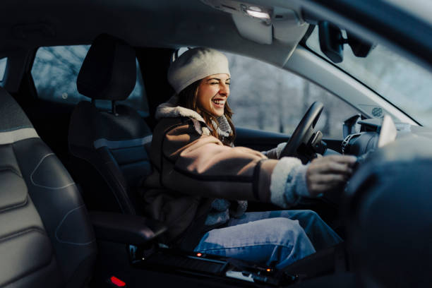istock Smiling young woman using global positioning system while driving her car 2181969927