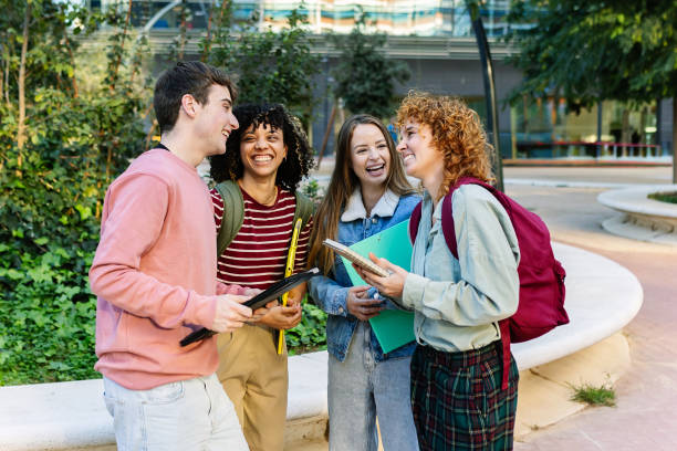 istock Cheerful group of young university students laughing together on campus 2181970658