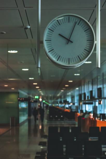A clock hanging in a train station displaying the time 22:03