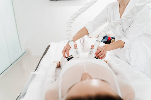 istock Lymphatic drainage apparatus is massaging woman sides. Effective therapy to remove destroyed fat sells. Massaging upper body to get rid of swelling. 2181971079