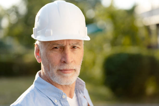 istock Senior engineer wearing hardhat supervising a construction site 2181971408