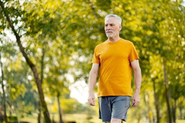 istock Senior man enjoying a relaxing walk in green park 2181971458
