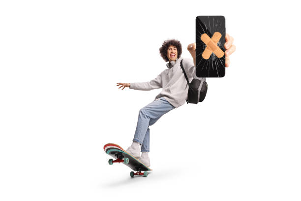 istock Guy riding a longboard and showing a smartphone with broken screen 2181975666