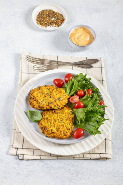 istock pumpkin carrot potato patties on plate, top view 2181977101