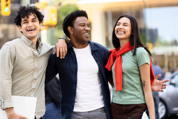 istock Three young professionals walking together in the city and laughing 2181977505