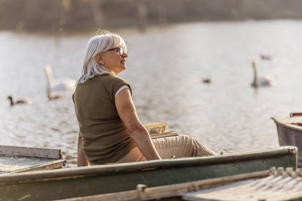 istock Exploring Nature: Woman Hiking By A Serene Lake with Backpack 2181978304