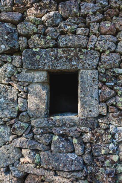 istock A close-up view of a rustic stone wall with irregularly shaped rocks, showing the textured, weathered surface of traditional masonry in a rural setting 2181980532