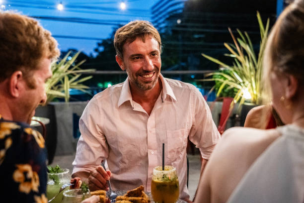 istock Mature man talking with friends on a rooftop 2181984077