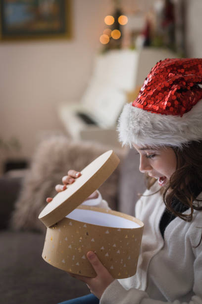 istock Surprised girl opening Christmas gift 2181984135