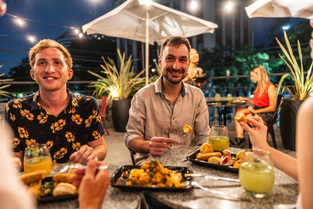 istock Friends talking and eating on a rooftop 2181984571