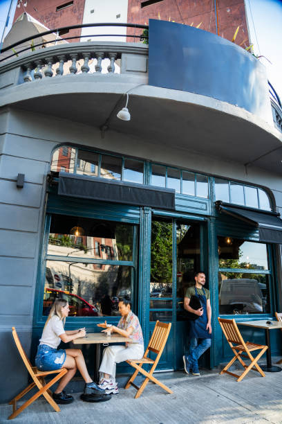 istock Friends talking on a sidewalk cafe 2181984871