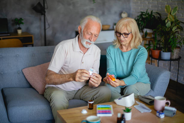 istock Senior couple are organizing their medication into a pill box 2181984893