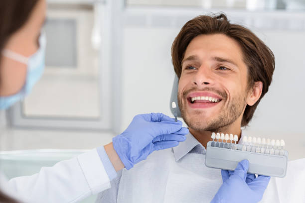 istock Dentist checking on male patient teeth color 2181986686