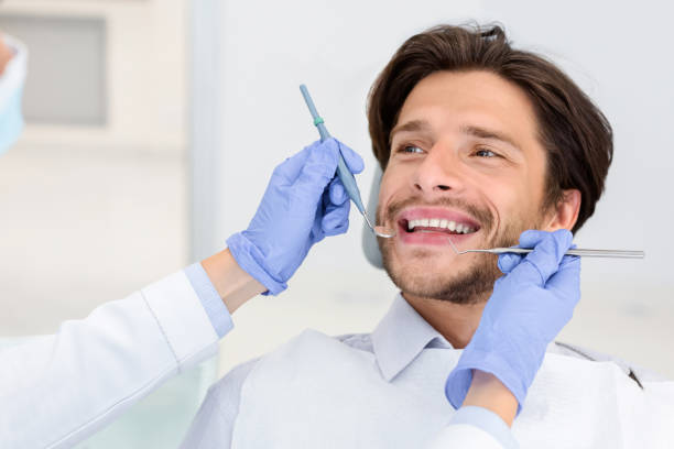 istock Smiling man looking at dentist with trust 2181986759