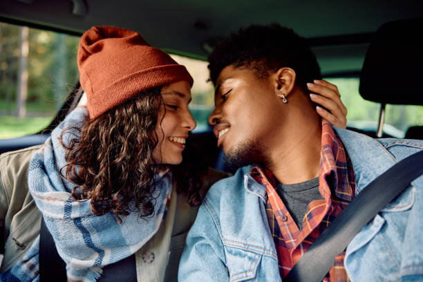 istock Young affectionate couple inside of a car. 2181987031