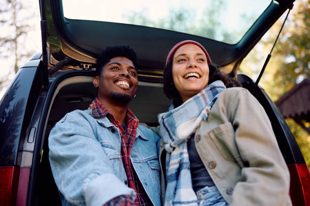 istock Happy multiracial couple enjoying in autumn day while relaxing in their camping van. 2181987459