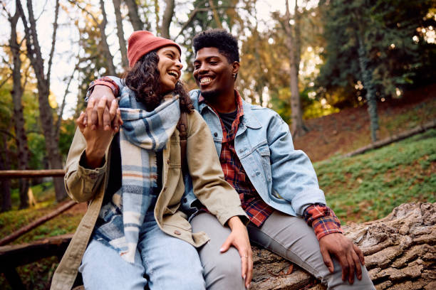 istock Happy multiracial couple laughing while spending autumn day in nature. 2181987848