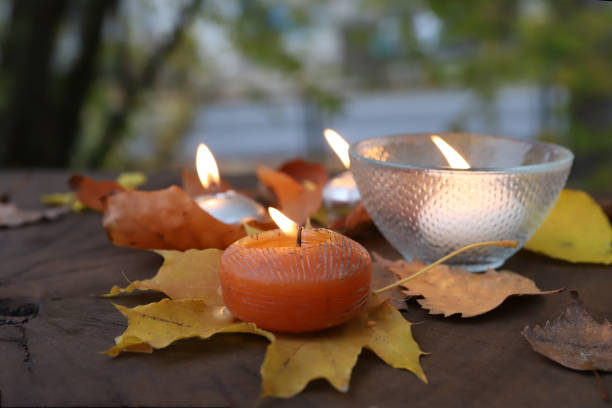 Autumn composition with candles and leaves outdoor.