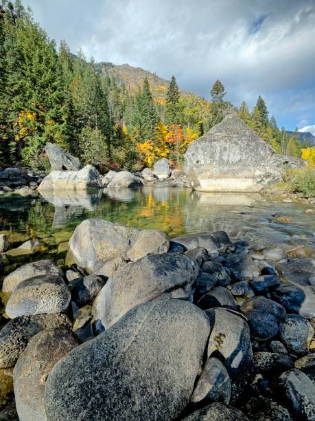istock Calm section of river surrounded by boulders. 2181988984