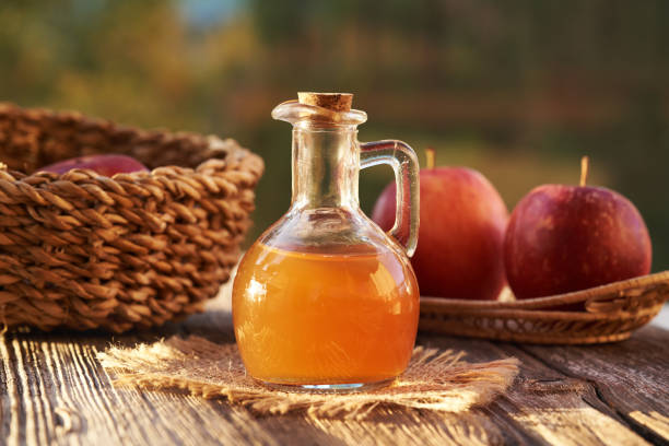 istock A bottle of unfiltered apple cider vinegar with red apples 2181989351