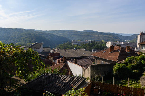 istock A tranquil view of serene hills and rustic rooftops in Gabrovo, Bulgaria under a bright blue sky 2181989736