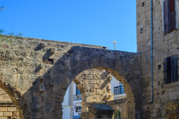 istock Exploring ancient stone arches beneath a clear blue sky in a historic coastal town 2181989934