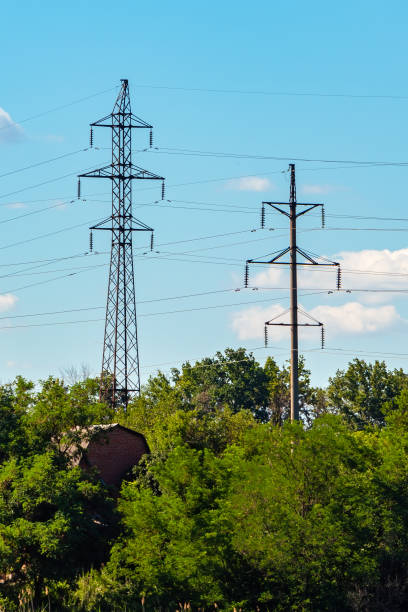 istock High voltage power transmission lines with metal and concrete support 2181992944