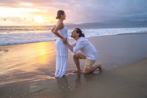 istock Couple expecting a baby at the beach 2181994338