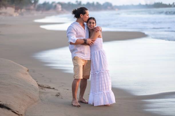 istock A married couple walking on the beach 2181994978