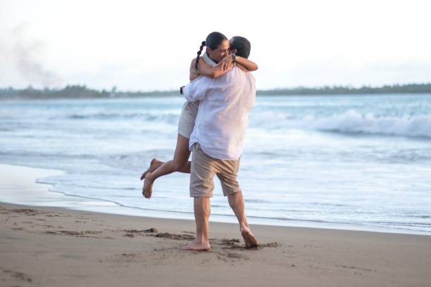 istock A married couple walking on the beach 2181995021
