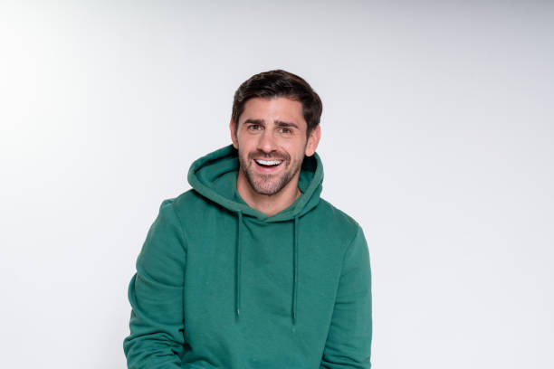 istock Smiling man wearing green hoodie posing on white background 2182001366