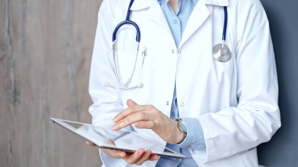 istock Doctor at work. Unrecognizable medical professional using digital tablet showcasing modern medical technology 2182001383