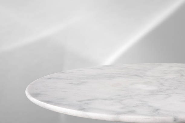 istock Round marble table top with abstract shadow drop on white wall background for mockup product display 2182007292