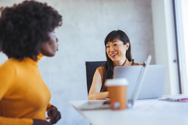 istock Business Women Engaged in a Friendly Office Conversation 2182007377