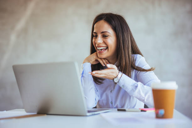 istock Smiling Woman Engaged in a Video Call on Laptop 2182007556