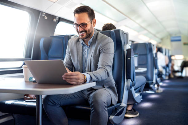 istock Handsome middle age businessman using his laptop computer while traveling with high-speed train. Modern and fast travel concept. 2182007682
