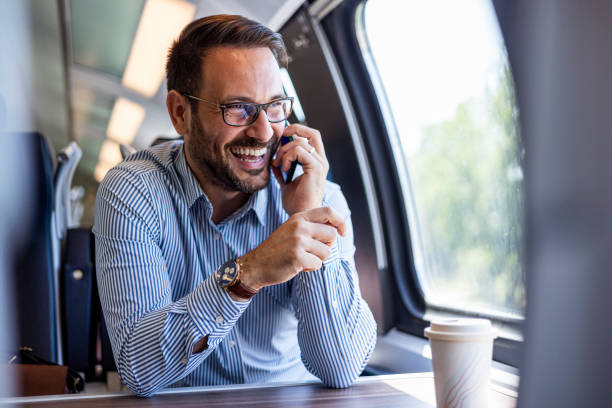 istock Young business man traveling to work by train, working while traveling, talking on phone. Young business man traveling to work by train. 2182007686