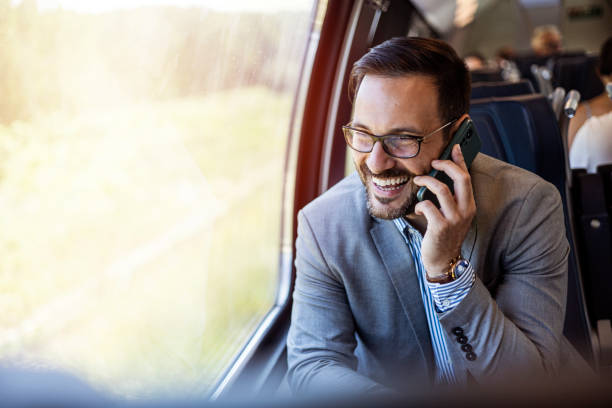 istock Young business man traveling to work by train, working while traveling, talking on phone. Young business man traveling to work by train. 2182007699