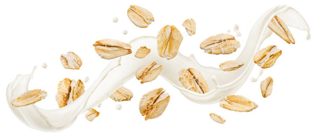 istock Falling oat flakes, oatmeal with milk splash isolated on white background, package design concept 2182008188