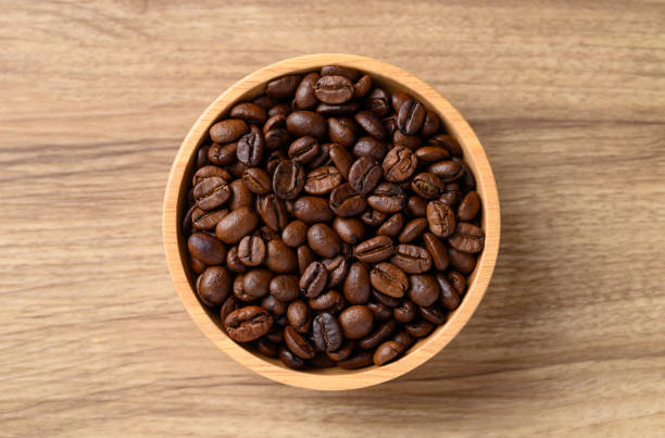 istock roasted coffee bean (Arabica coffee) in bowl on wooden background 2182008283