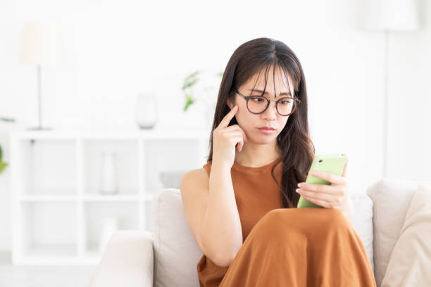 istock attractive Asian woman using a smart phone, trouble 2182012847