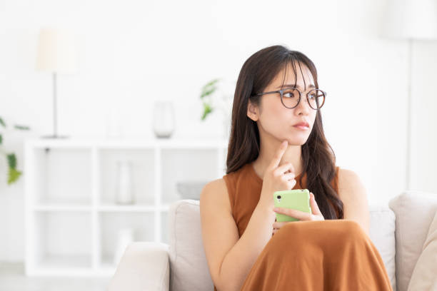 istock attractive Asian woman using a smart phone, trouble 2182012853