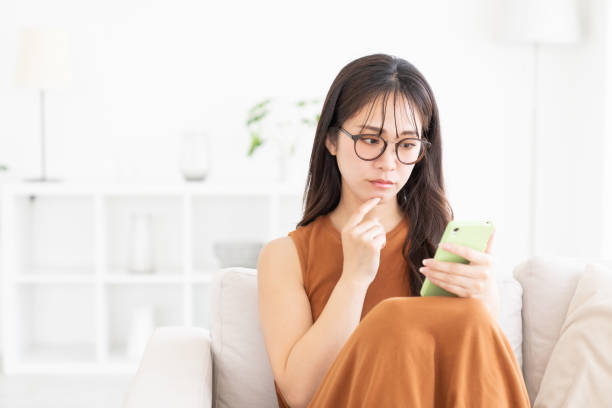 istock attractive Asian woman using a smart phone, trouble 2182012954
