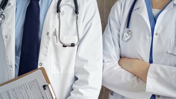 istock Professional healthcare team in uniform. Two doctors with stethoscopes are standing straight with arms crossed. Medicine concept 2182013196