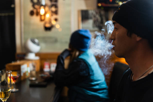 istock Man exhaling smoke at bar 2182021503