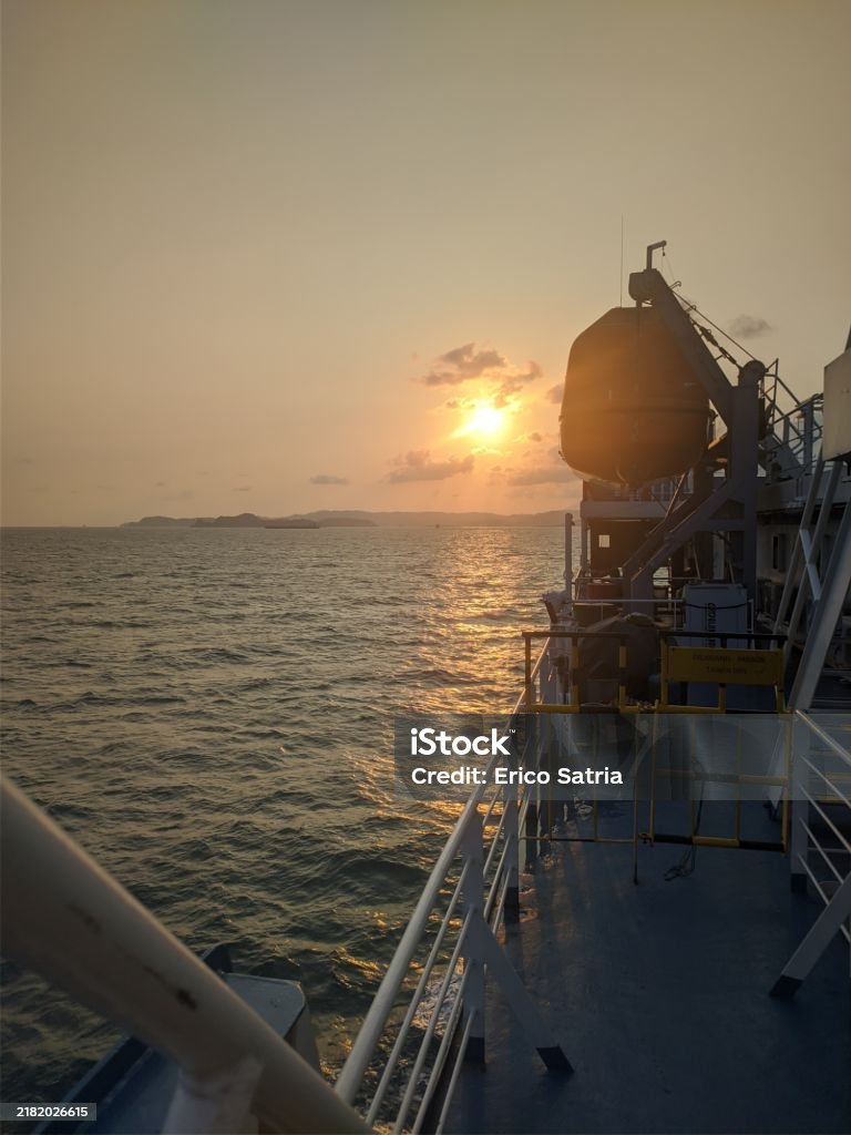 Beautiful Sunset From a Ship in the middle of the sea Bakauheni - Merak Ferry crossing in indonesia Bay of Water Stock Photo Beautiful Sunset From a Ship in the middle of the sea Bakauheni - Merak Ferry crossing in indonesia Bay of Water Stock Photo