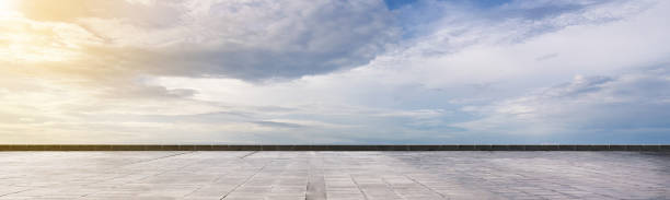 istock Cement floor view with blue sky and clouds in the background 2182029472
