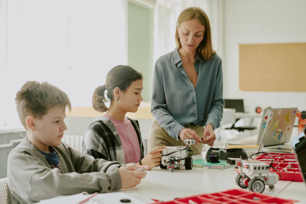 istock Female Teacher Helping Students with Robot 2182033502