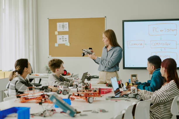 istock Female Teacher Showing Robot Parts 2182033551
