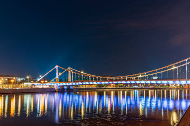 Krymsky Bridge or Crimean Bridge in Moscow at summer night. Steel suspension bridge in Moscow over the Moskva River